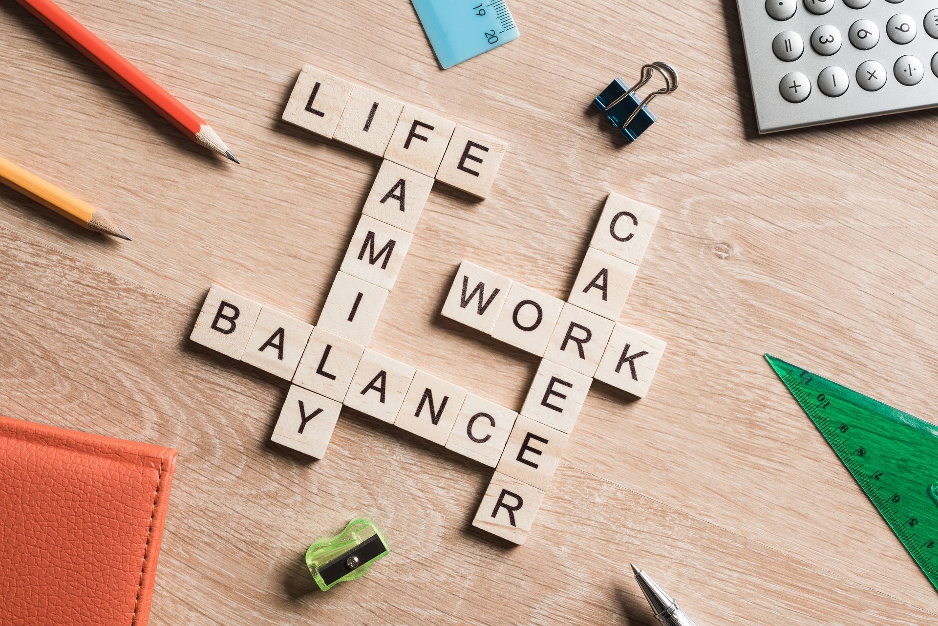 A wooden crossword puzzle with the words life , work , balance , and y written on it.