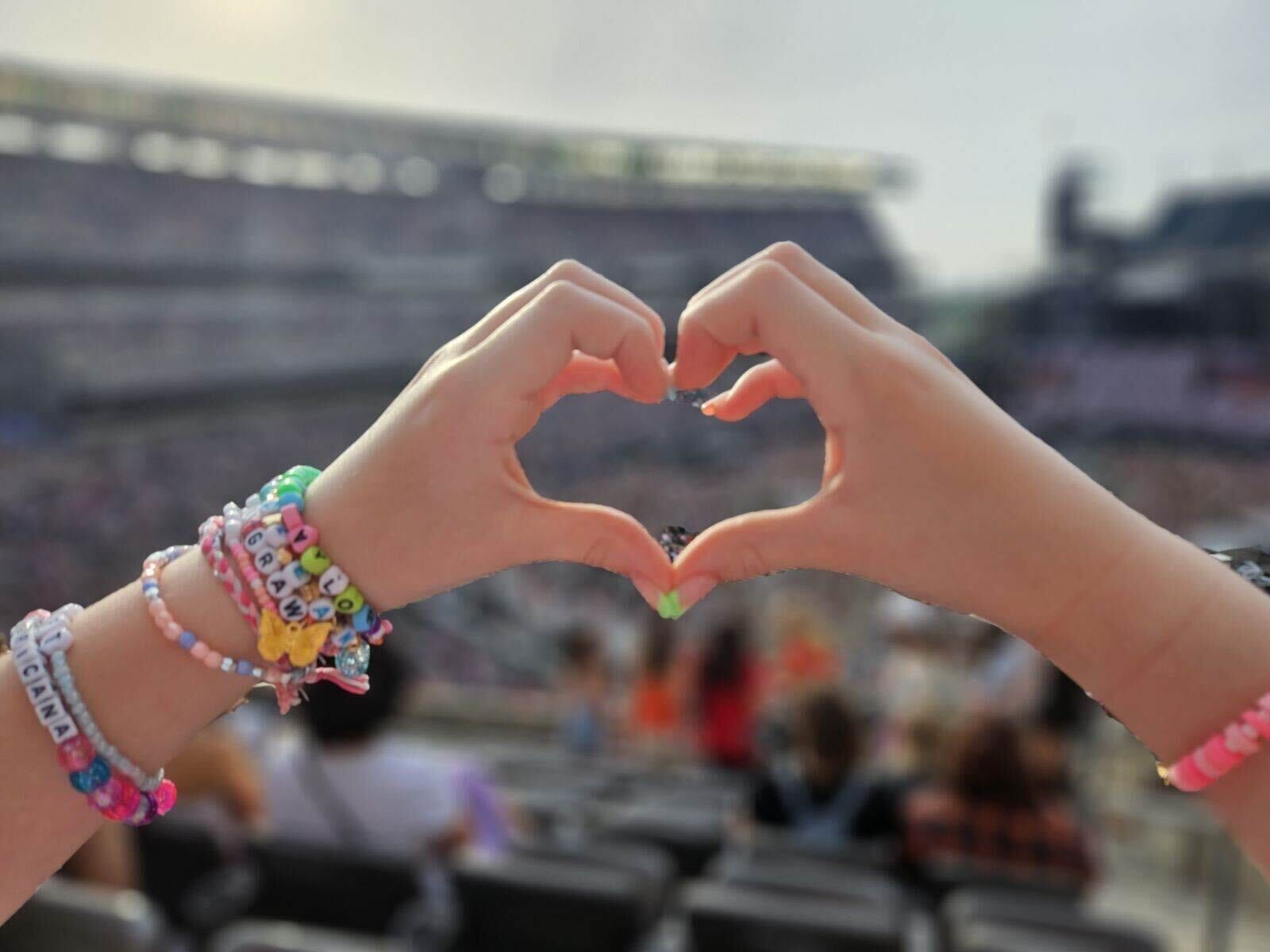 A person making a heart shape with their hands