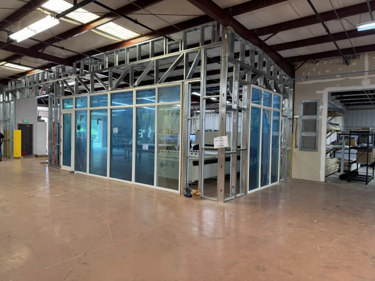 Industrial training room with metal framing and blue panels inside a warehouse
