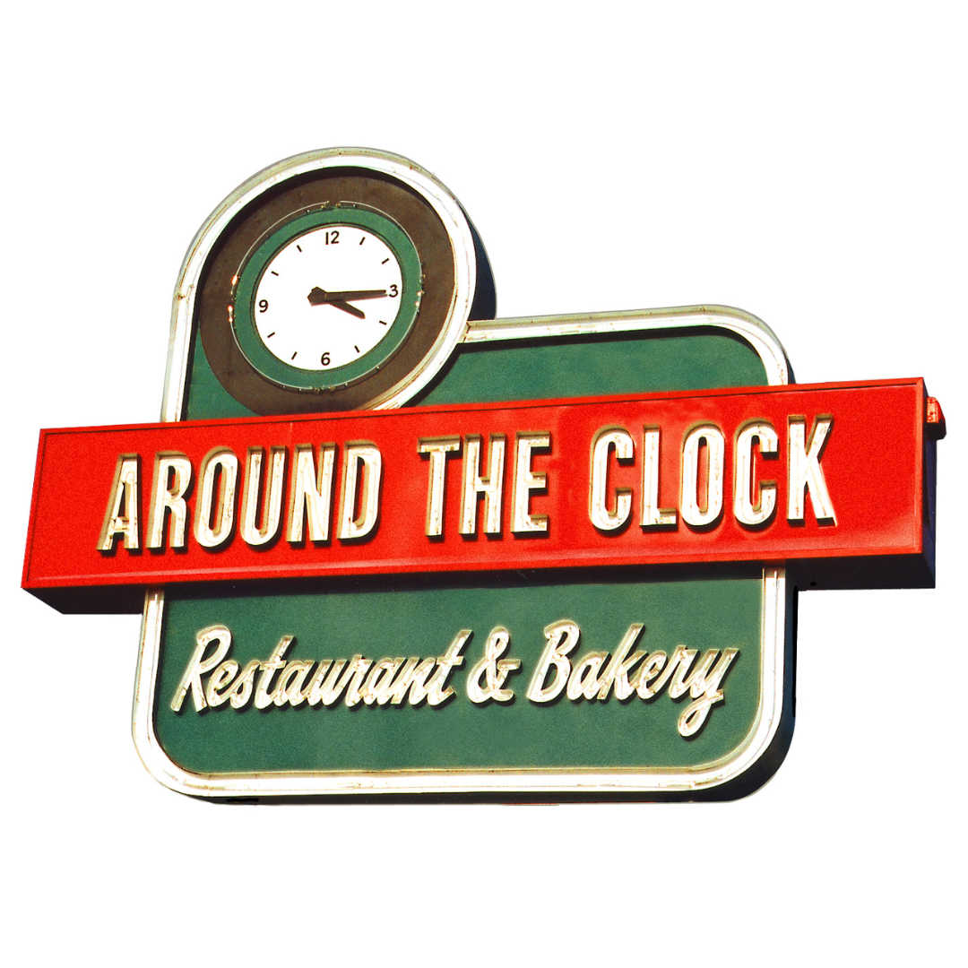 A sign for around the clock restaurant and bakery