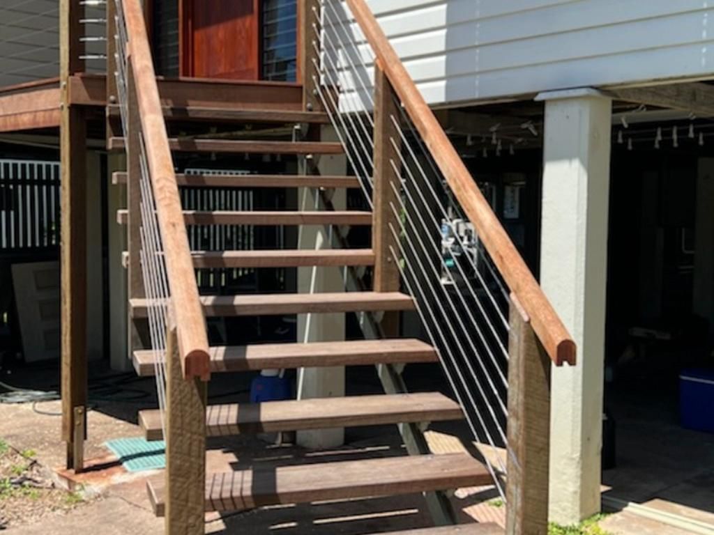 A Set Of Wooden Stairs Leading Up To A House — Quality Fabrications & Welding Pty Ltd In Bohle, QLD