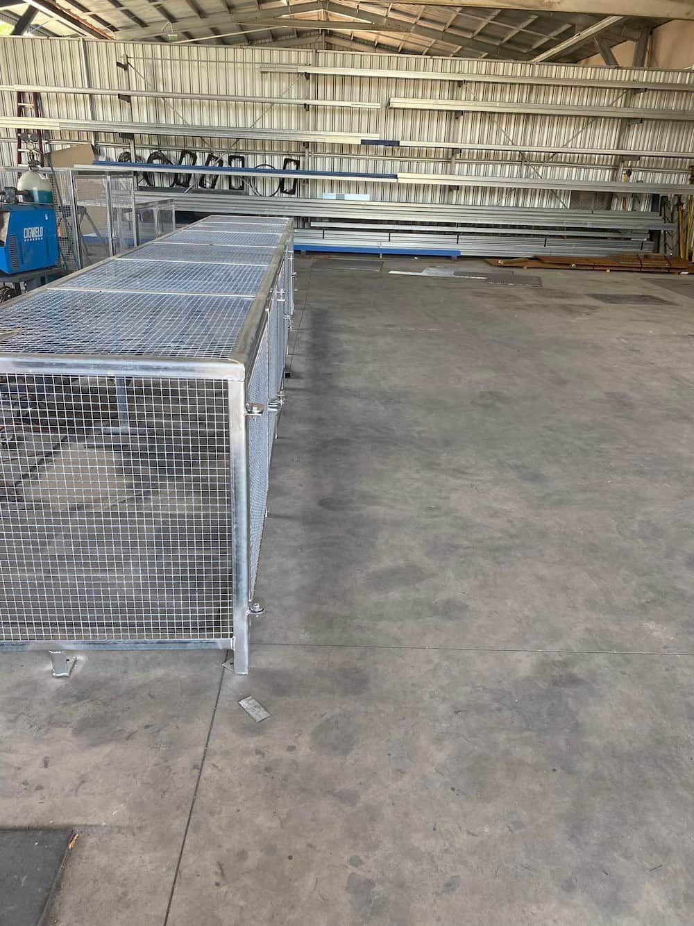 A Large Warehouse Filled With Lots Of Metal Crates — Quality Fabrications & Welding Pty Ltd In Bohle, QLD