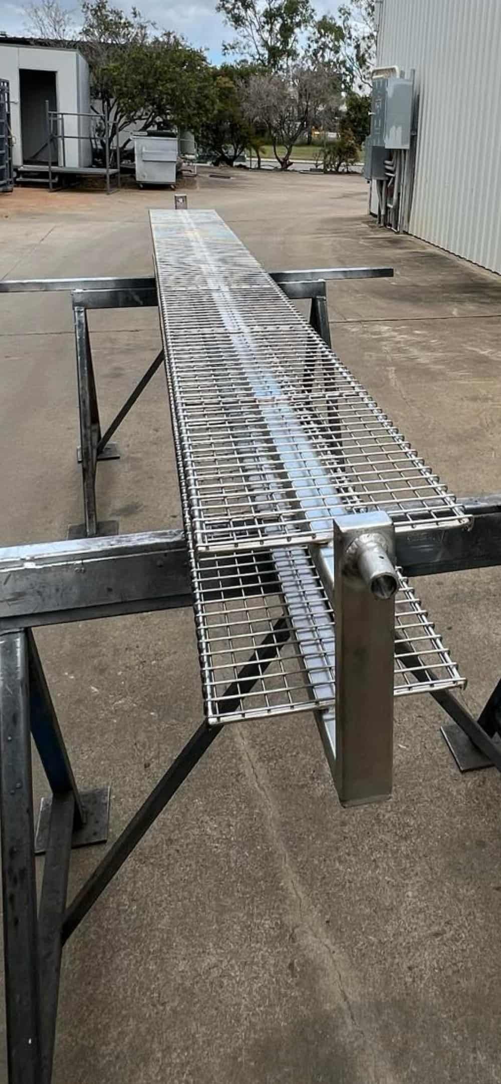 A Long Piece Of Metal Is Sitting On Top Of A Metal Table — Quality Fabrications & Welding Pty Ltd In Bohle, QLD