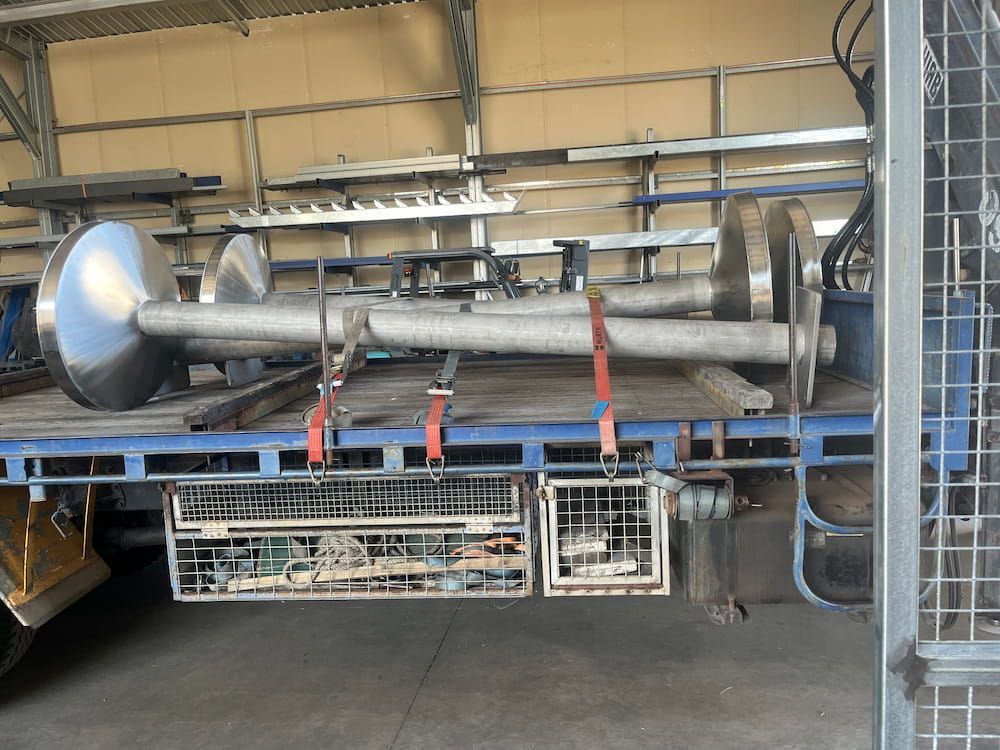 A Large Metal Pipe Is Sitting On The Back Of A Truck — Quality Fabrications & Welding Pty Ltd In Bohle, QLD