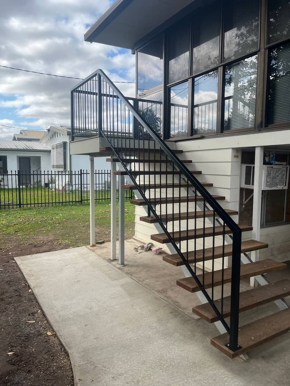 A Set Of Stairs Leading Up To A Balcony On The Side Of A House — Quality Fabrications & Welding Pty Ltd In Bohle, QLD