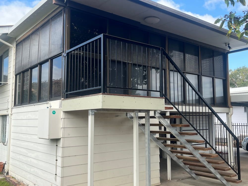 A White House With Stairs Leading Up To The Second Floor — Quality Fabrications & Welding Pty Ltd In Bohle, QLD