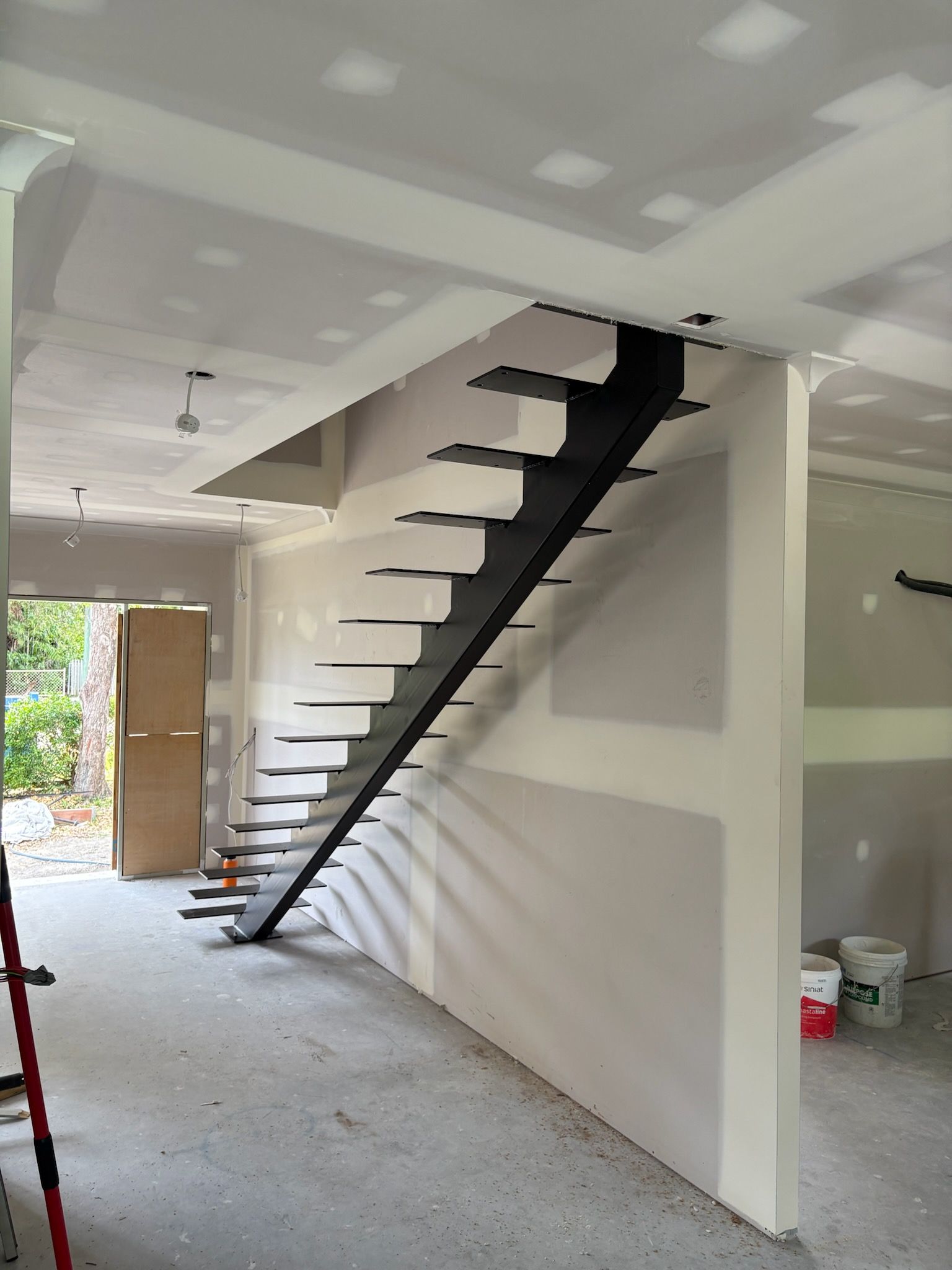 A White House With Stairs Leading Up To The Front Door — Quality Fabrications & Welding Pty Ltd In Bohle, QLD