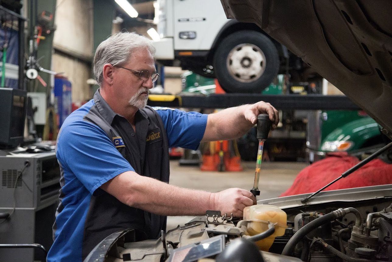 A man servicing a car | Joey's Truck & Auto Repair