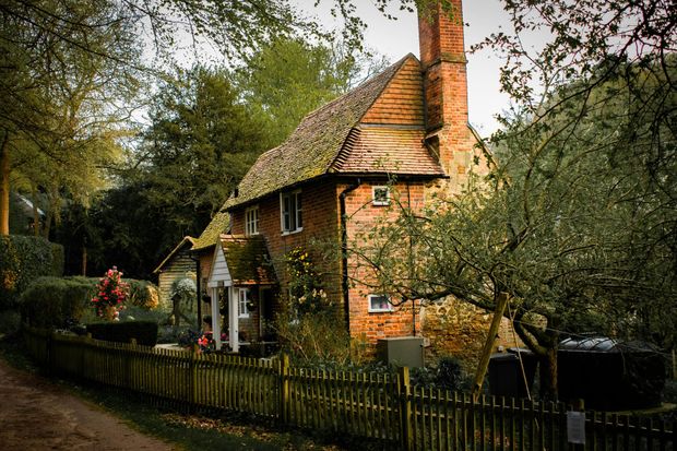 A brick house with a wooden fence around it