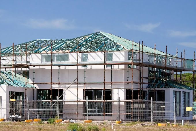 A house is being built with scaffolding around it.
