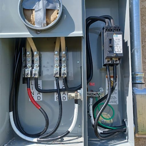 A close up of a electrical box with wires coming out of it