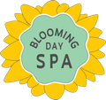 Blooming Day Spa logo with a green center and yellow flower petals