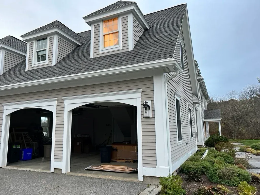 A large house with a garage and a roof.