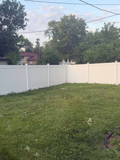 A person is cutting a tree branch with a chainsaw.