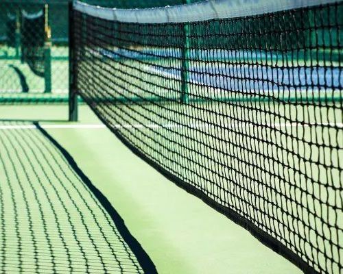 A close up of a tennis net on a court