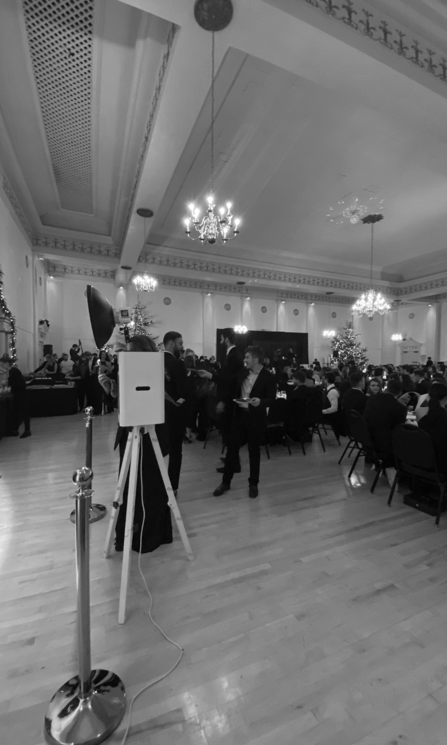 A black and white photo of a large room filled with people.