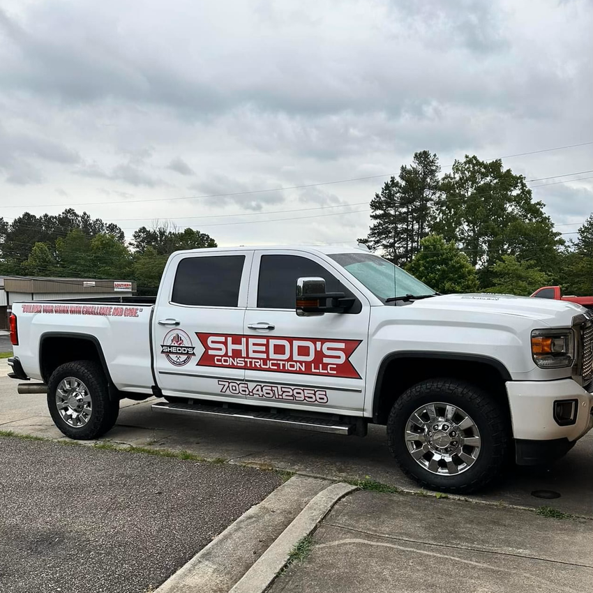 A white pickup truck is parked in a parking lot.