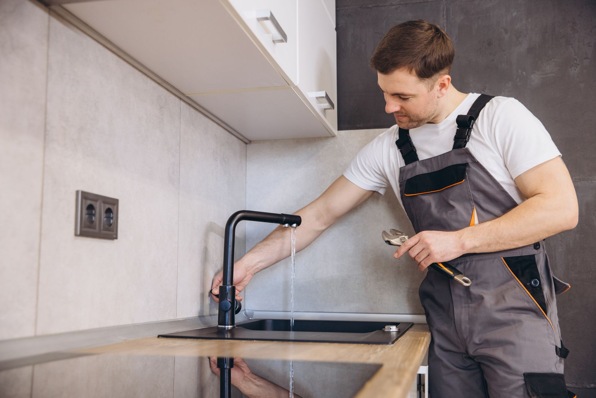 A professional plumber testing a faucet after completing a home water softener replacement service