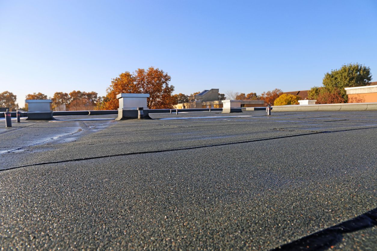 A close up of a roof with a blue sky in the background.