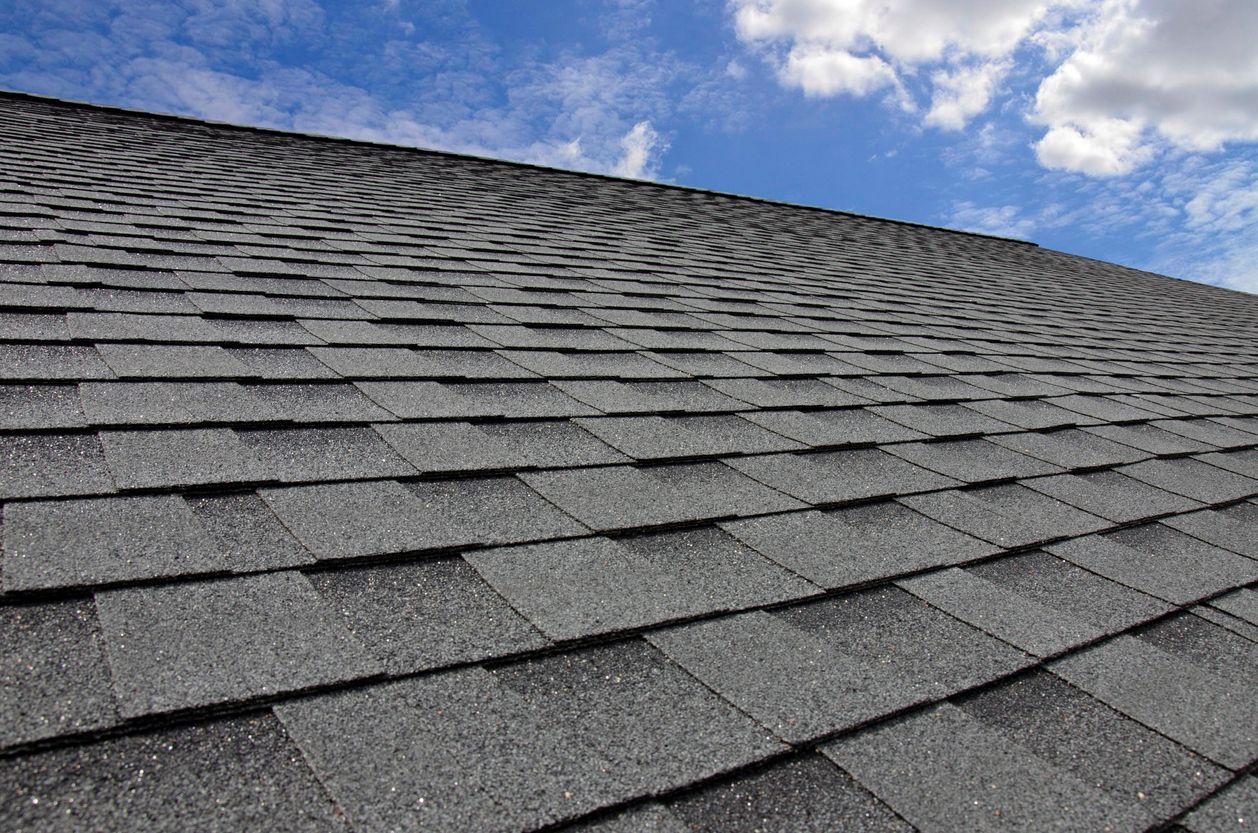 A close up of a roof with a blue sky in the background.