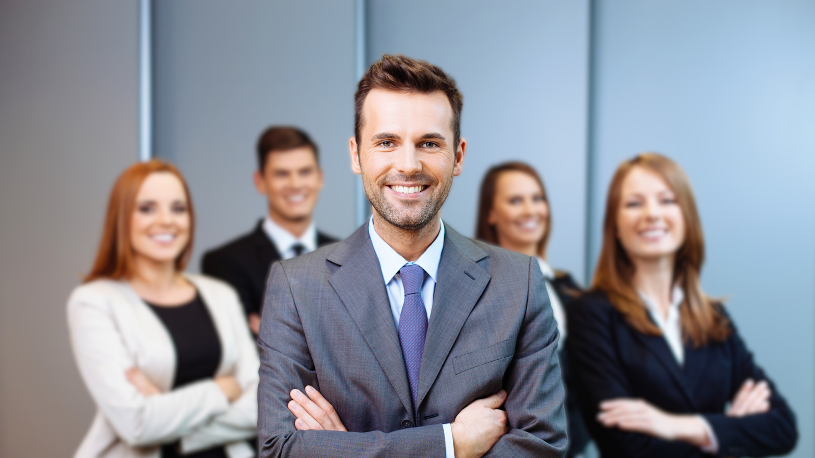 Smiling business team with crossed arms in the office.