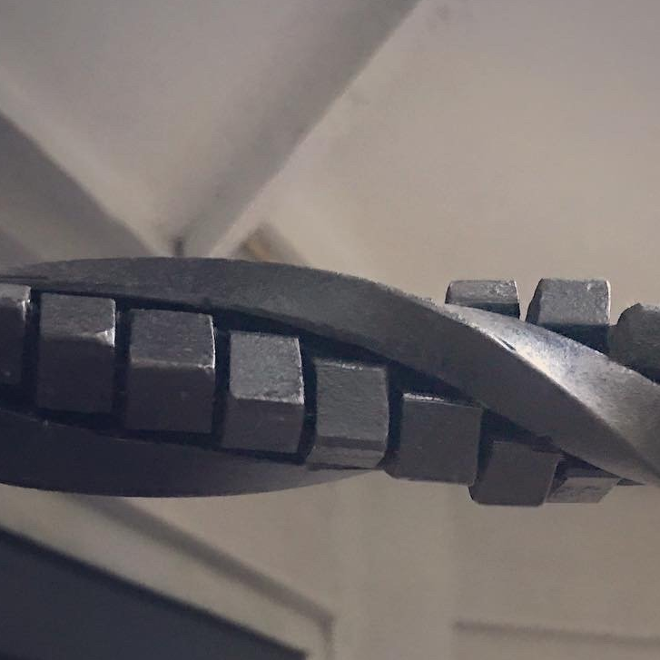 A close up of a metal object with squares on it