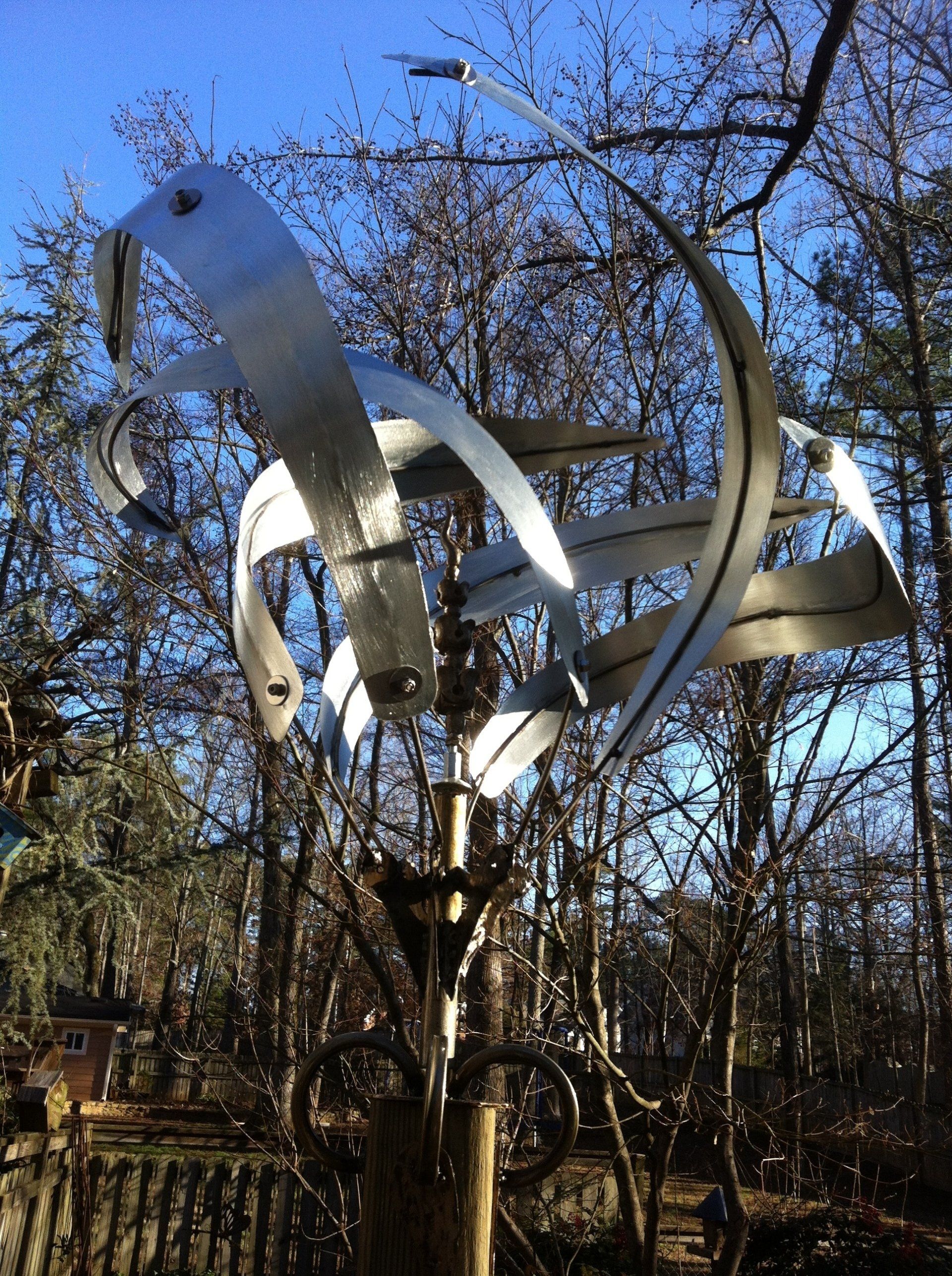 A large metal sculpture in the middle of a forest