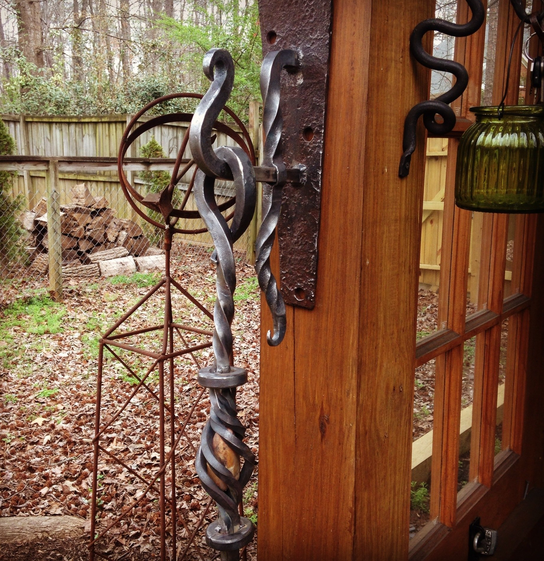 A wooden door with a wrought iron handle on it