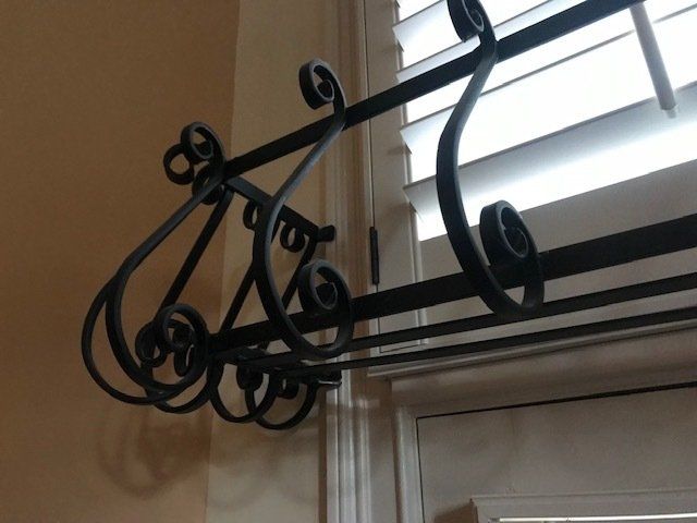 A wrought iron railing is attached to a window