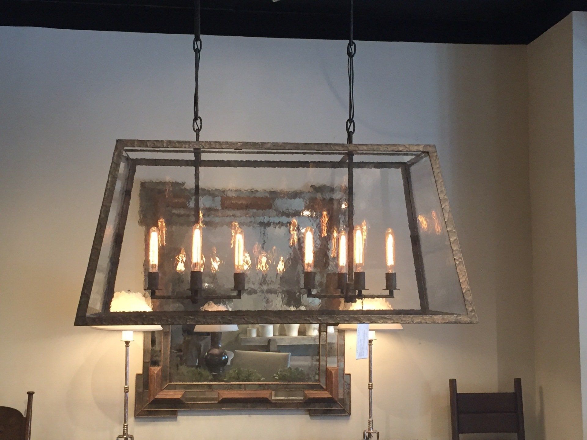 A dining room with a large chandelier hanging from the ceiling