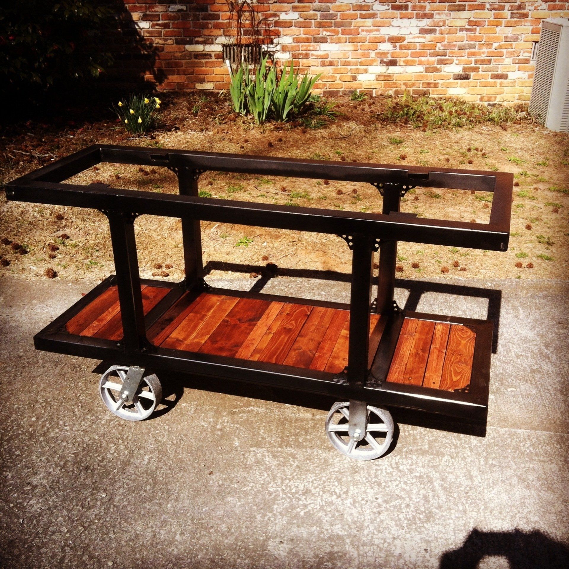 A cart with wheels and a wooden top