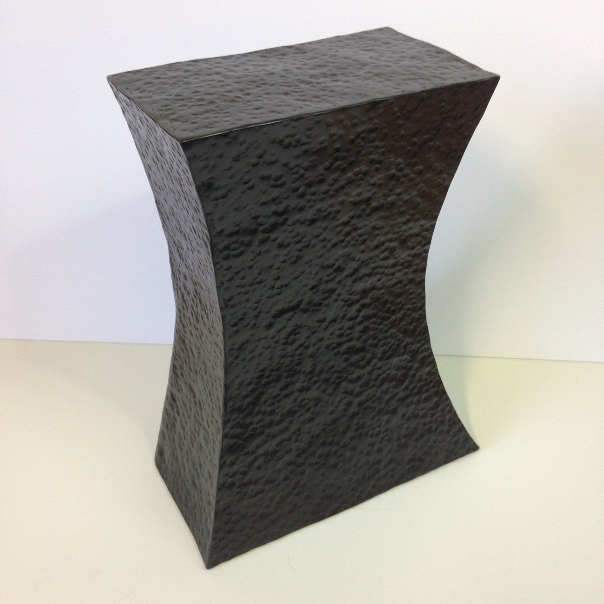 A black block is sitting on a white surface