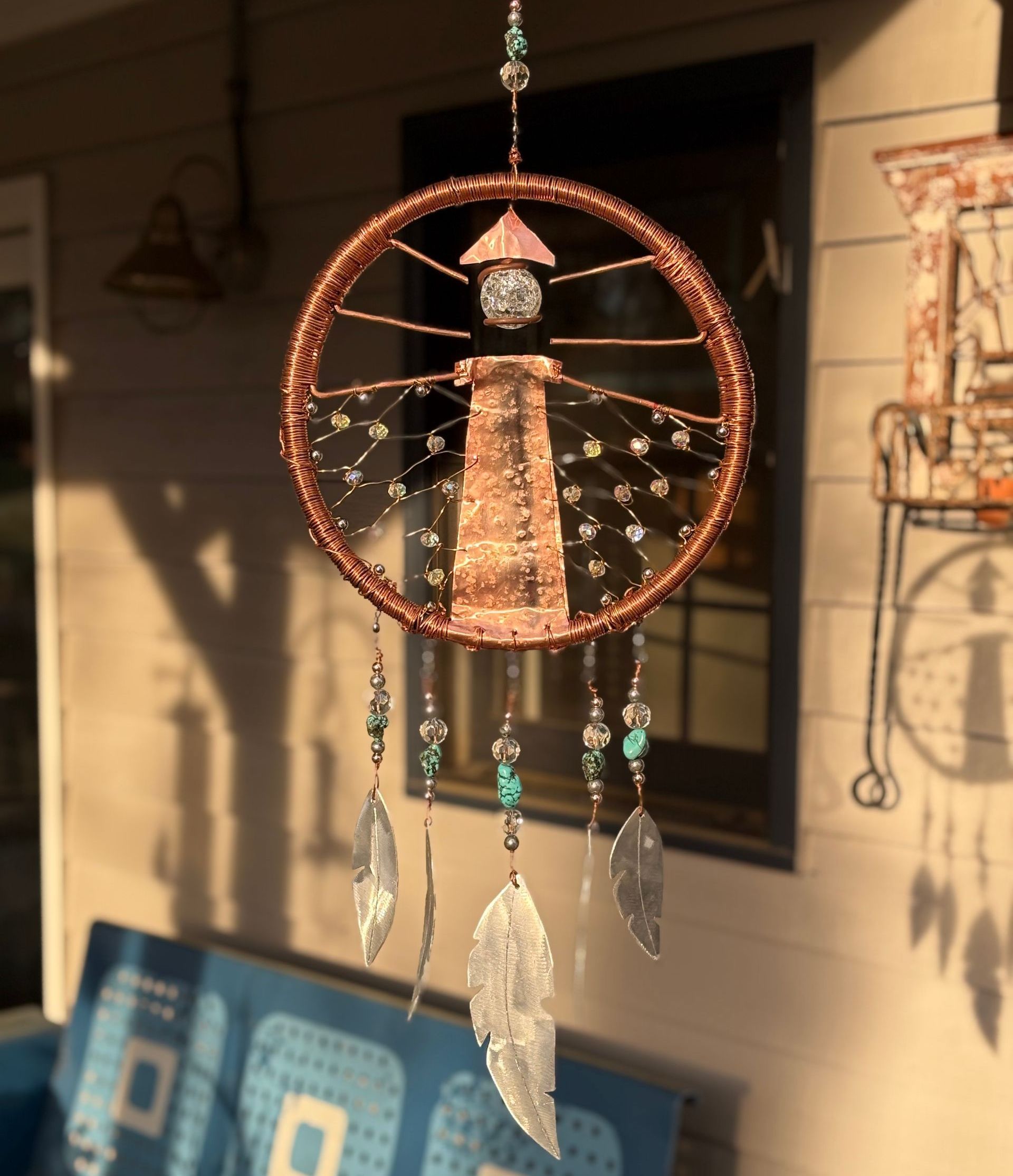 A dream catcher with a lighthouse in the middle
