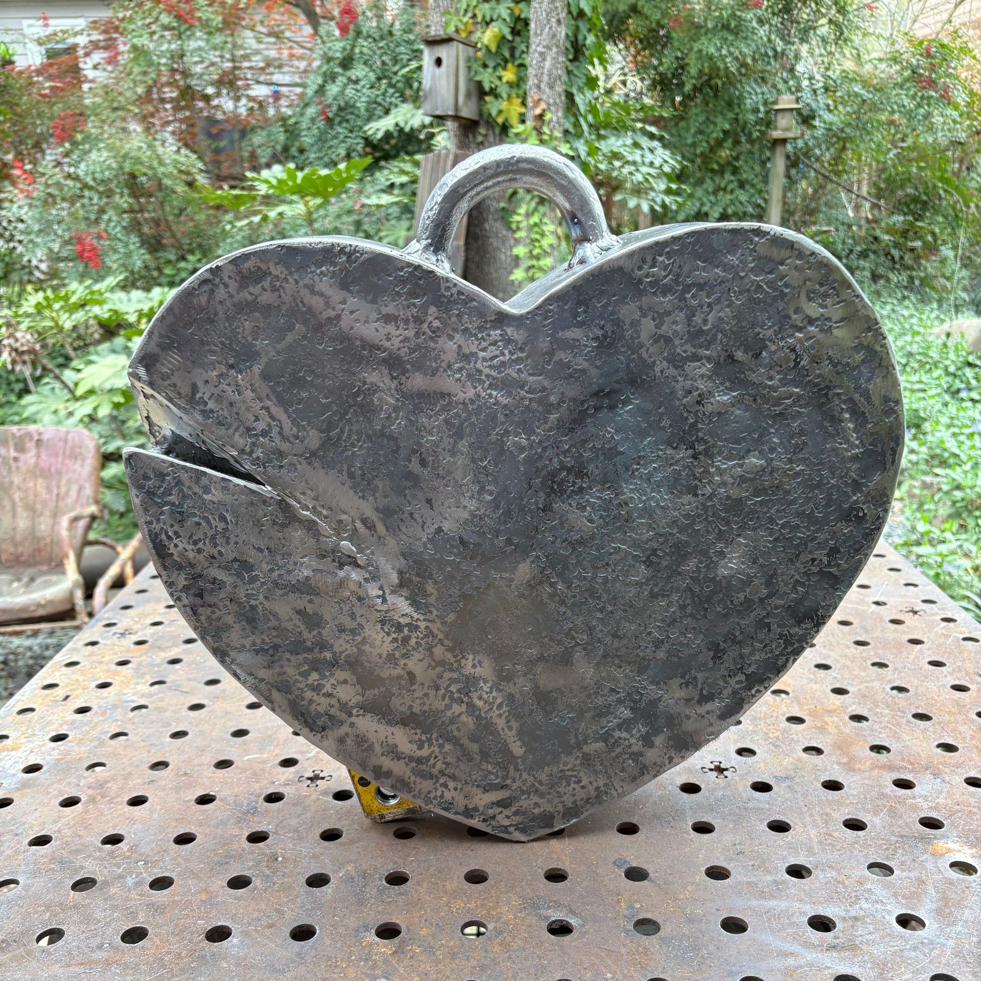 A heart shaped object is sitting on a metal table