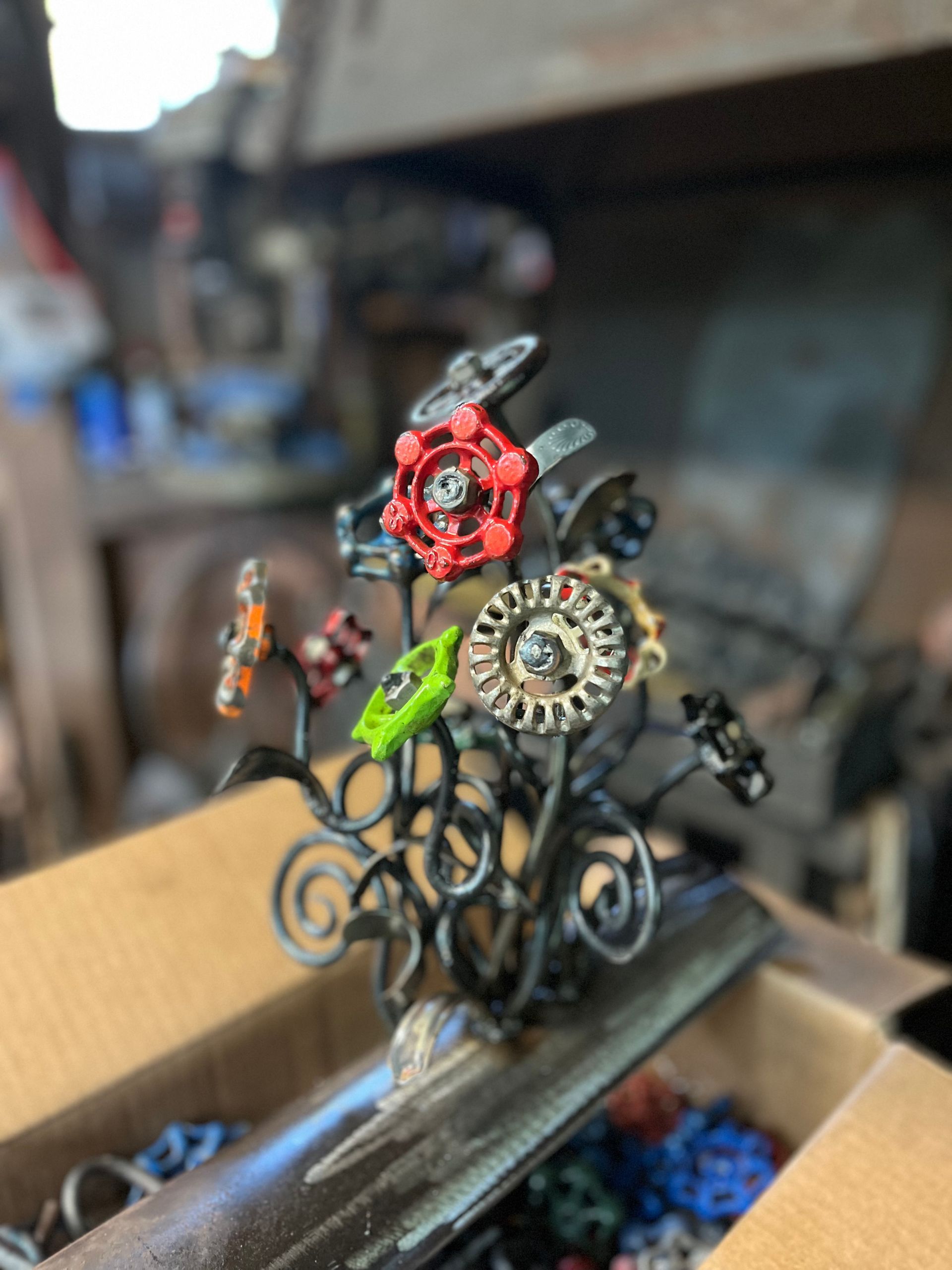 A bunch of metal flowers are sitting on top of a box