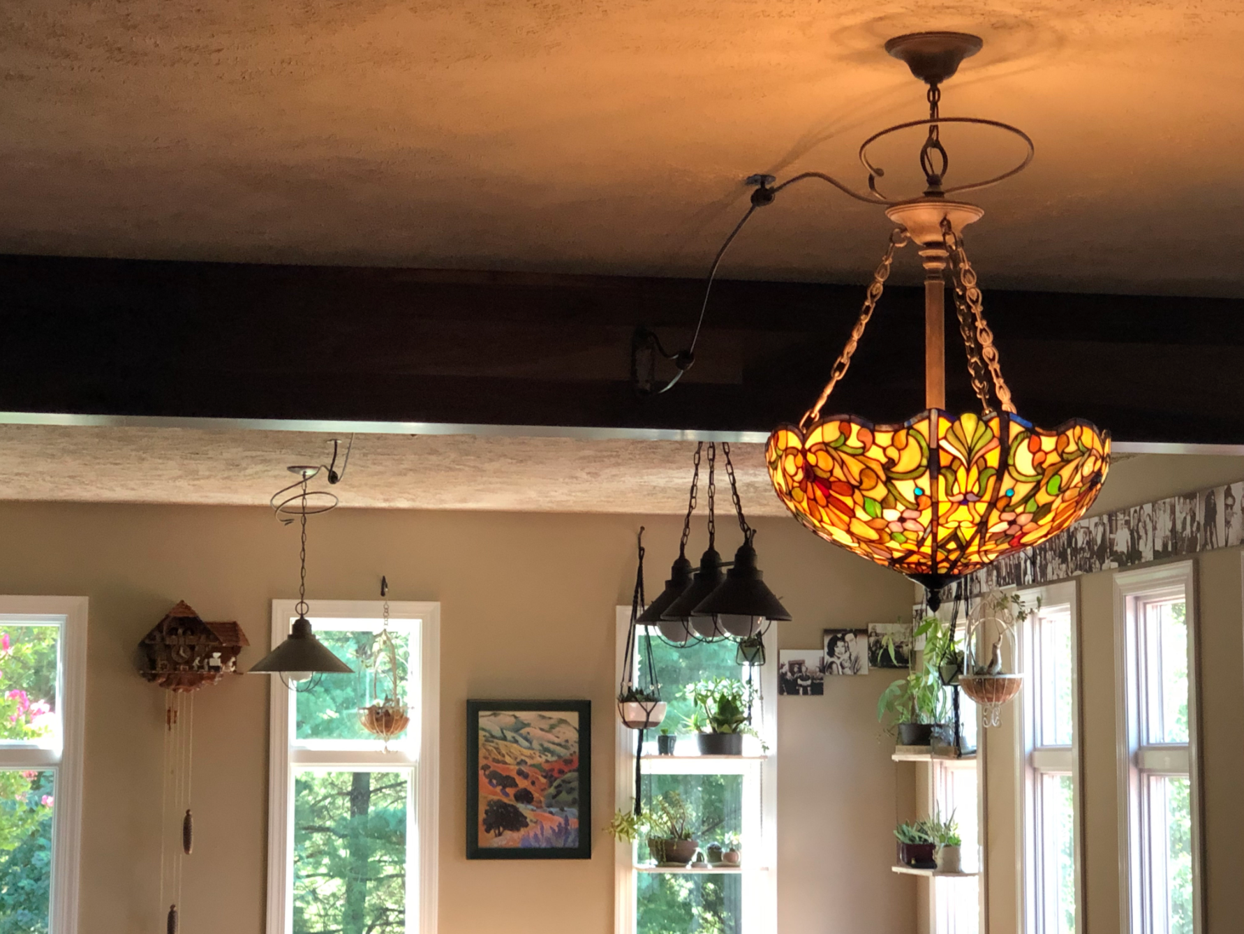 A stained glass chandelier hangs from the ceiling in a living room