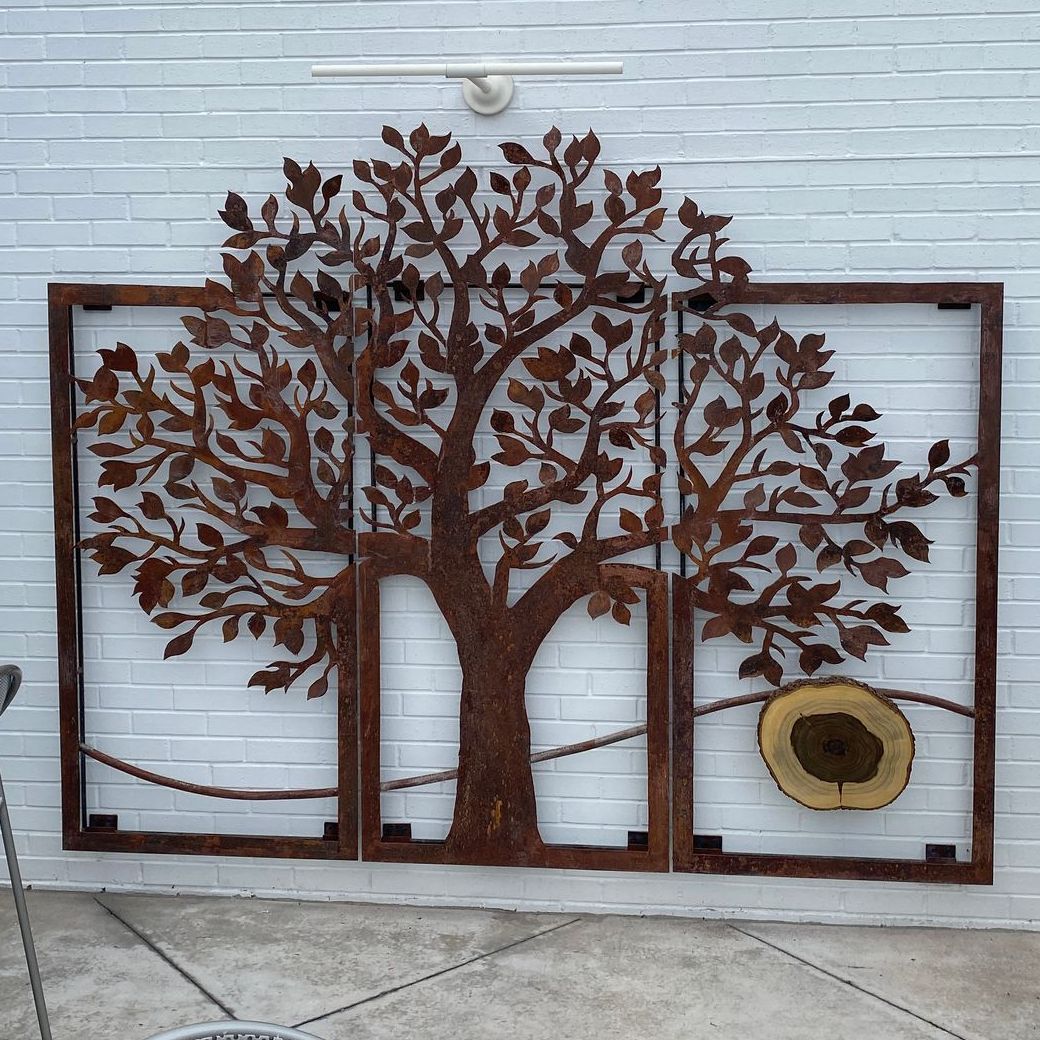 A picture of a tree on a white brick wall