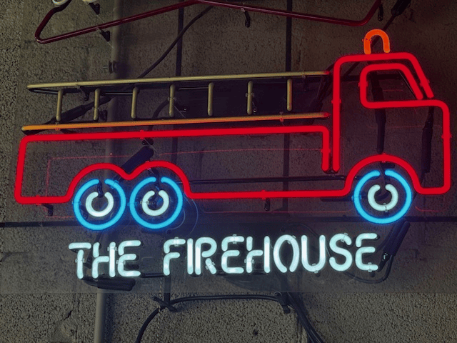 Neon sign: red firetruck, ladder, and 