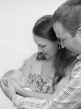 Couple cuddling a baby - Law Firm in Denver, CO Couple cuddling a baby - Law Firm in Denver, CO