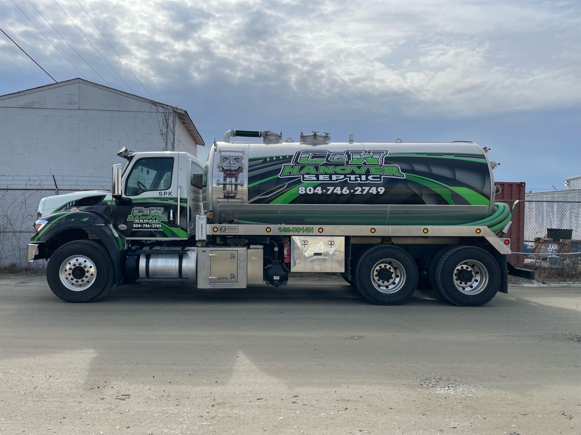 a green and white tanker truck is parked on the side of the road . | Mechanicsville, VA | C & W Hanover Septic a green and white tanker truck is parked on the side of the road . | Mechanicsville, VA | C & W Hanover Septic