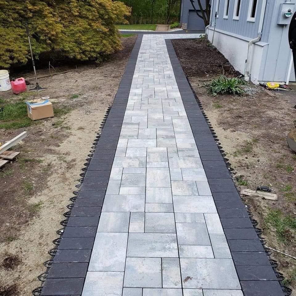 A walkway is being built in front of a house