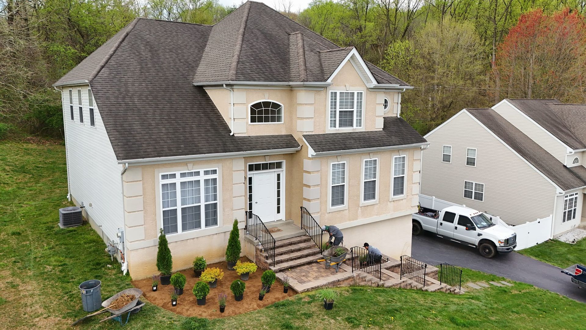 An aerial view of a large house with a truck parked in front of it.