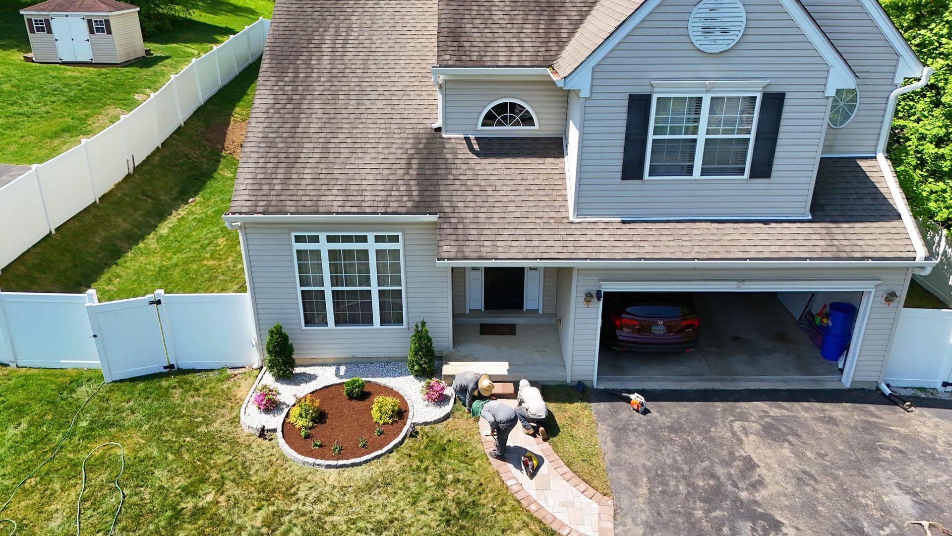 An aerial view of a house with a car parked in the garage.