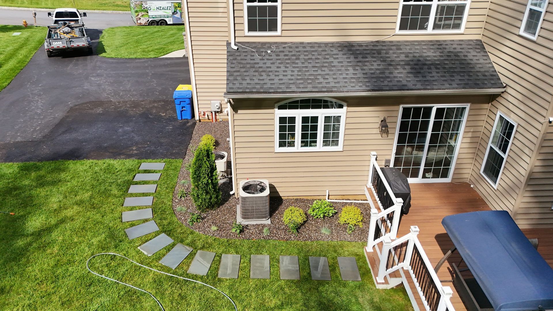 An aerial view of a house with a walkway leading to it