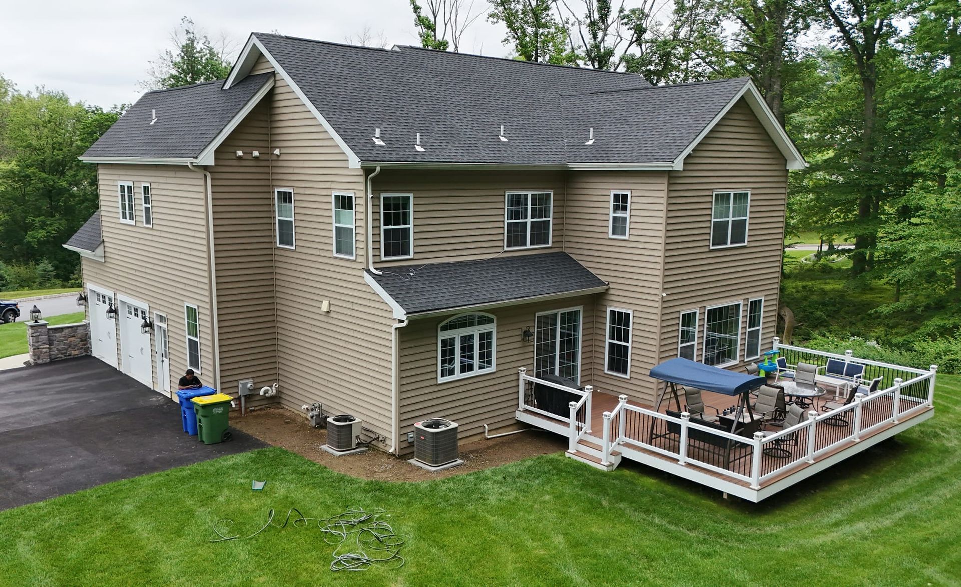 An aerial view of a large house with a large deck.
