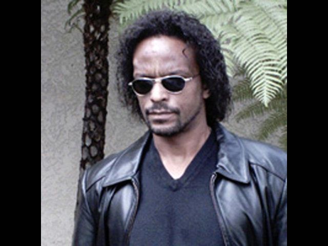 A man wearing sunglasses and a black leather jacket