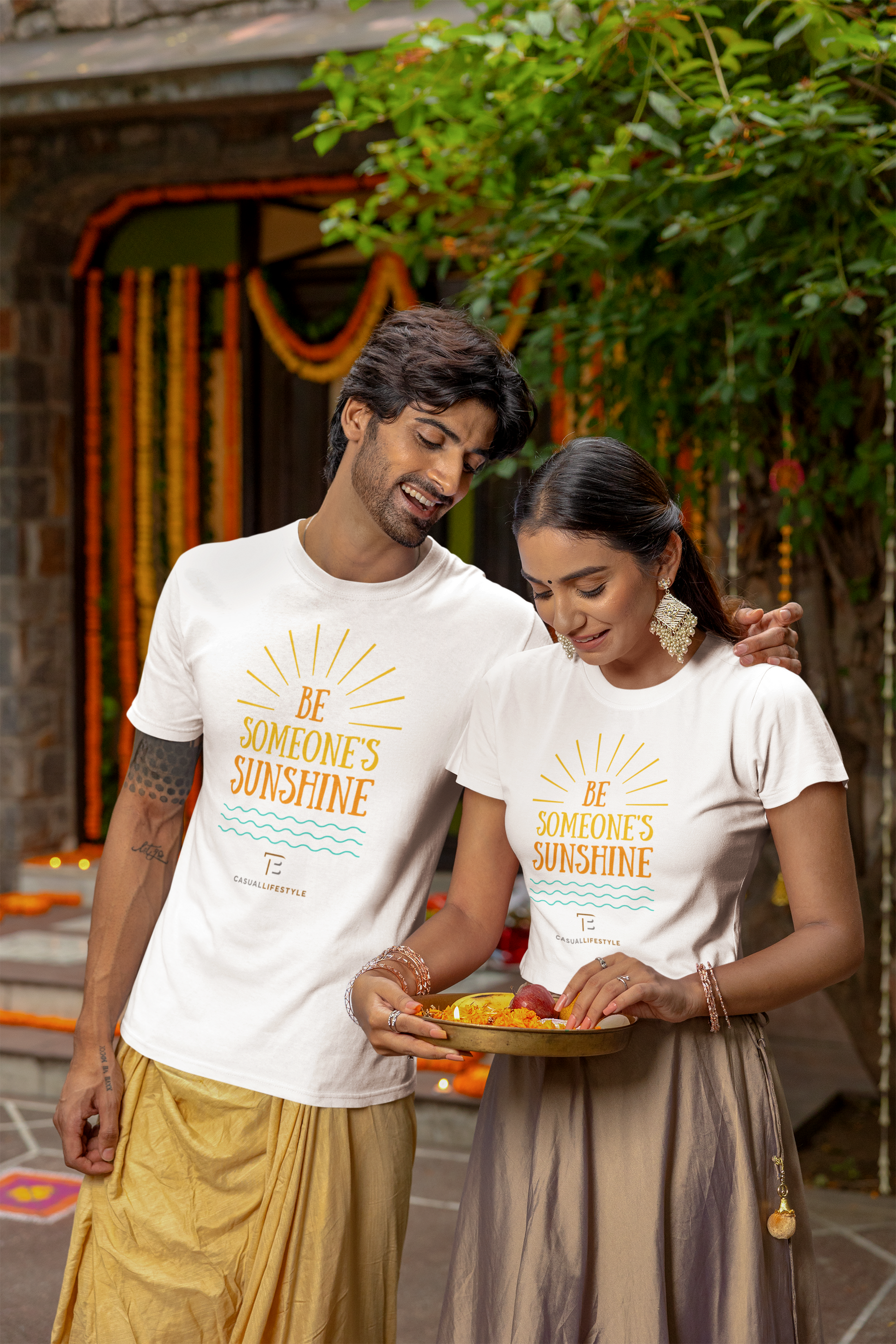A man and a woman are standing next to each other holding a plate of food.