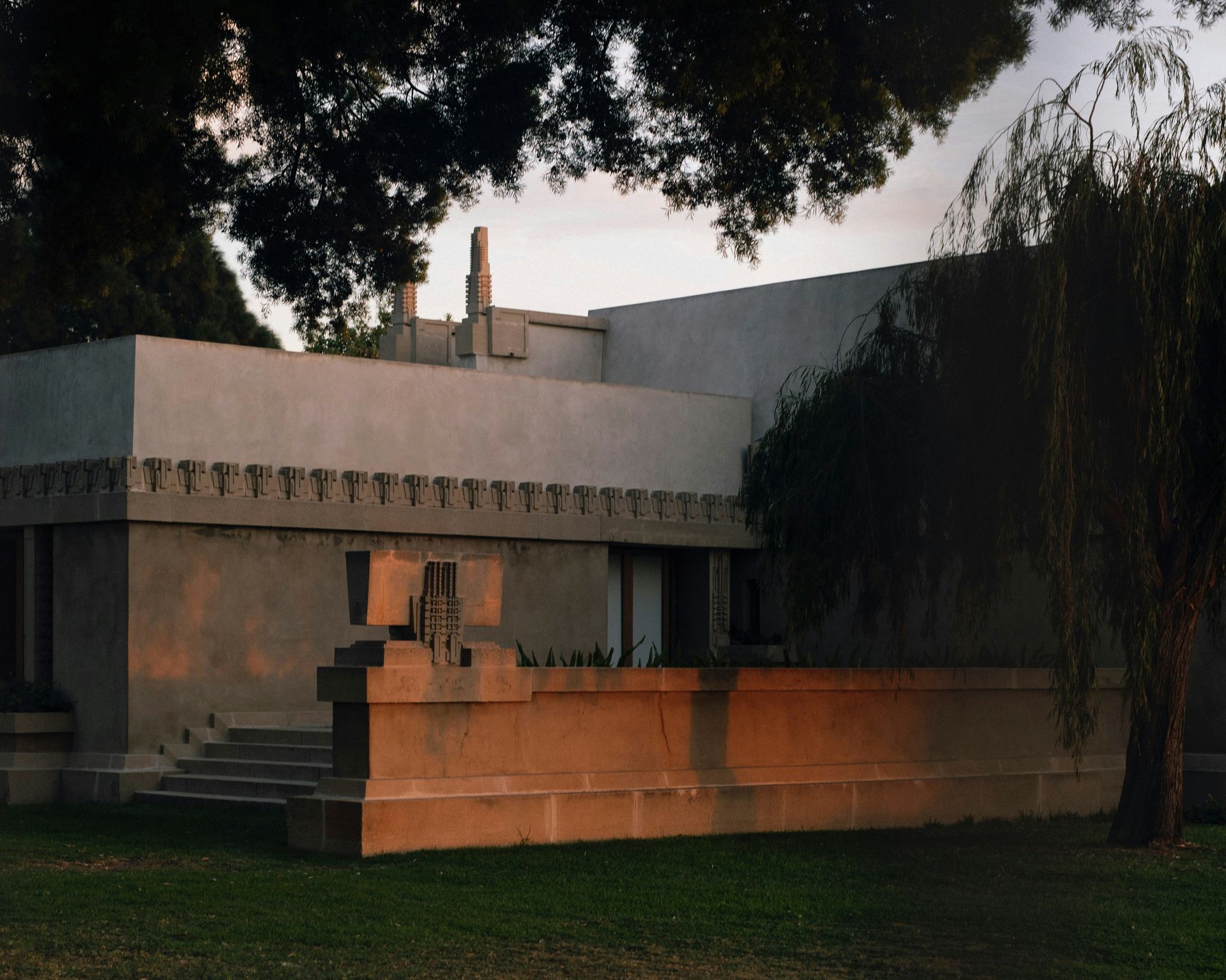 A large white building with a tree in front of it