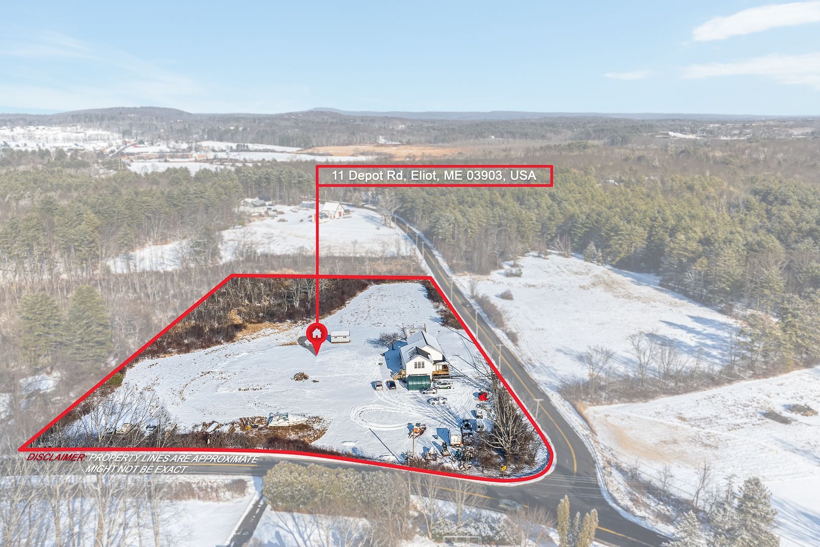 Aerial view of snow-covered land, a house, and a road. Marked with a red outline and text.