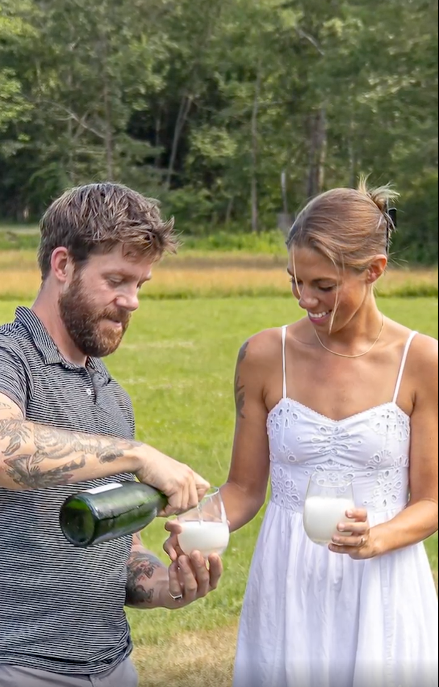 Night aerial view of trees illuminated with colorful Christmas lights.